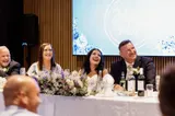 Bride and groom smiling during a toast